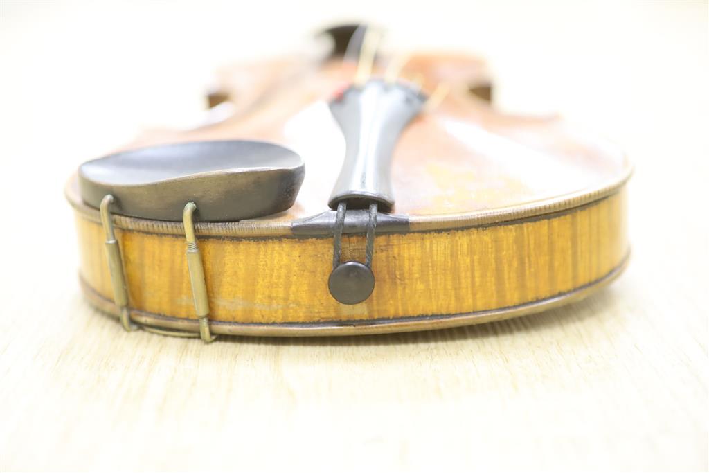 A late 19th century violin and a bow, cased